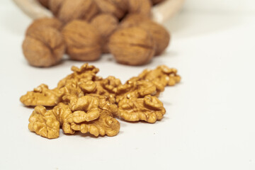 walnut kernels and whole nuts on a light background