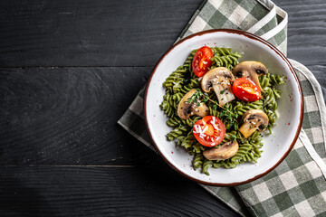 Penne pasta with white mushrooms in creamy sauce. italian Penne pasta with champignon mushroom. Spring pasta with green vegetables. top view
