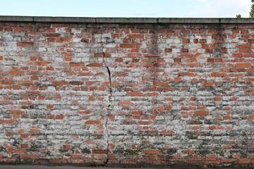 Old brick wall with faded white paint as background in Schweinfurt, Germany