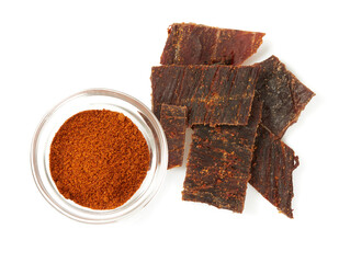 Beef jerky with hot pepper isolated on white background. Dried meat.