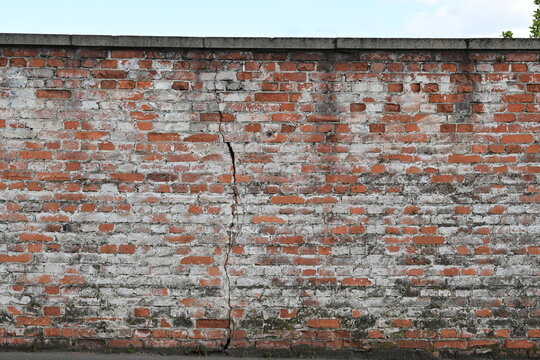 Old brick wall with faded white paint as background in Schweinfurt, Germany
