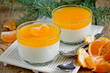 Italian dessert panna cotta with tangerine jelly layer in a glass