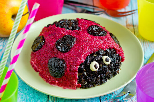 Herring salad with beetroot shaped funny ladybug for kids meal