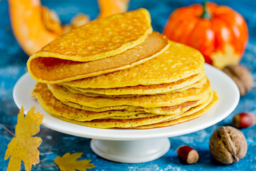 Pumpkin pancakes , stack of delicious pumpkin pancakes on white plate