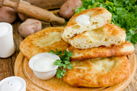 Flatbread langos langosh from potato yeast dough deep fried , Hungarian cuisine