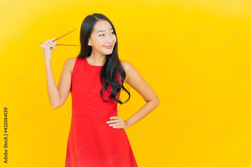 Wall mural portrait beautiful young asian woman with chopstick