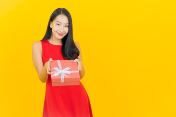 Portrait beautiful young asian woman smile with red gift box