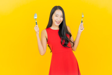 Portrait beautiful young asian woman smile with spoon and fork