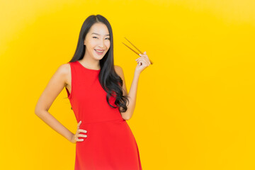 Portrait beautiful young asian woman with chopstick