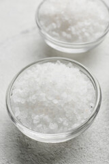 Bowl with salt on white background