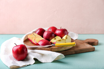 Tray with fresh red apples and knife on table