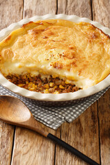 Pate chinois is a French Canadian dish similar to the English shepherd's pie it is a traditional recipe in both Quebec cuisine closeup in the baking dish on the table. Vertical