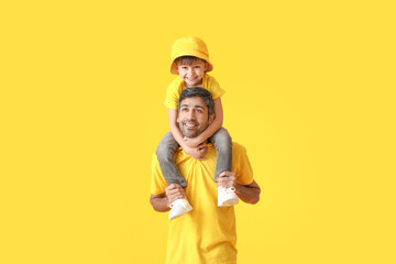 Happy father and his little son on color