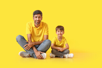 Fototapeta na wymiar Happy father and his little son on color