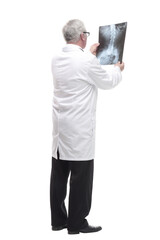 full-length. qualified mature doctor looking at the x-ray.