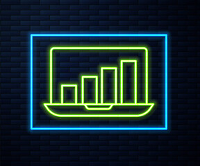 Glowing neon line Laptop with graph chart icon isolated on brick wall background. Report text file icon. Accounting sign. Audit, analysis, planning. Vector