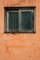 Old window with orange wall