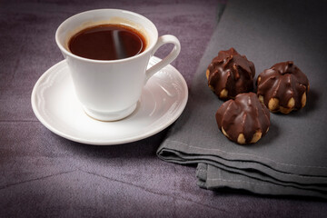cup of coffee with chocolate eclair