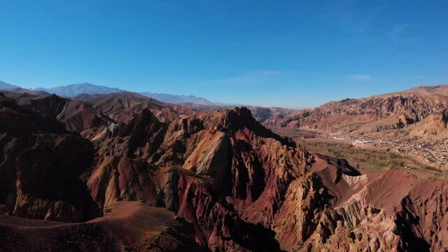 Afghanistan's Red City In Bamyan, Man Standing On Top Of Cliff Overlooking Scenery - aerial drone shot