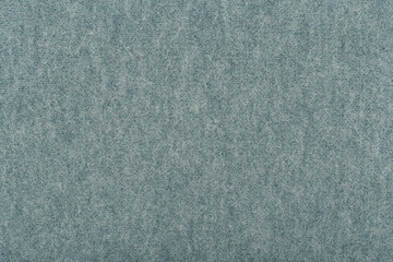 Blue flocky fabric close up. Warm, cozy material background with space for text. Concept of template
