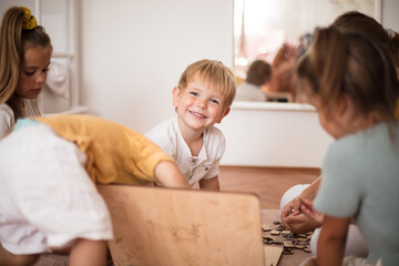 Large group of kids playing interactive games. Focus is on background.