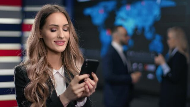 Smiling blonde business woman chatting use smartphone at hi tech innovation office workspace
