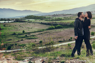 A loving couple walking in the mountains.