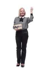 Fototapeta premium in full growth. Mature business woman with gift box .