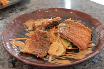 Fried salmon salad on a plate