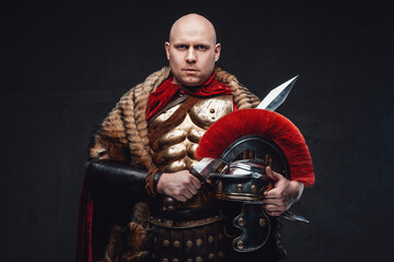 Serious roman soldier weared in fur and bronze armor