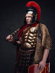 Roman soldier weared in bronze armor holding sword