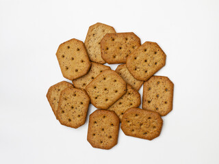 Bunch of spicy wholegrain crackers. Isolated. Top view, flatlay.
