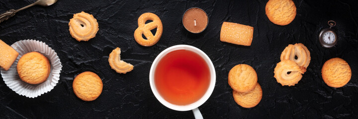 Danish butter cookies panorama, shot from the top on a dark background