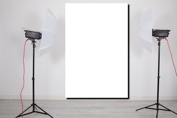 mockup empty room with blank white screen poster studio lights on tripod stands in Concept...