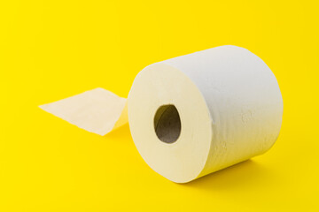 Toilet paper roll on yellow background