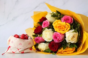 Bouquet of flowers, colorful sugar candies, and a cute teddy bear. A perfect gift combo for birthday and happy valentine's day. Rose flowers. I love you. Happy mothers day greetings. copy space.