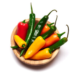 Wooden bowl full of Chili or sweet peppers isolated on white background