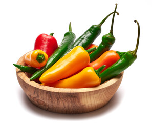 Wooden bowl full of Chili or sweet peppers isolated on white background