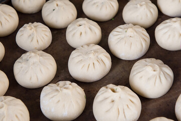 Fototapeta premium Chinese traditional food steamed stuffed buns in a container
