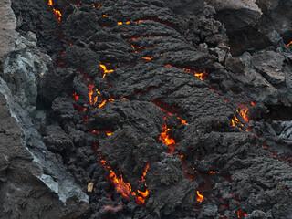 Closeup view of glowing lava rocks cooling down after volcanic eruption in Geldingadalir valley...