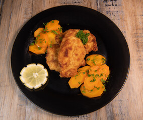 Recipe for breaded chicken cutlet, glazed carrots. High quality photo