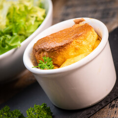 Cheese egg souffle on rustic cloth on a wooden background, Parmesan and Gruyere cheese souffle,...