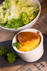 Cheese egg souffle on rustic cloth on a wooden background, Parmesan and Gruyere cheese souffle, High quality photo