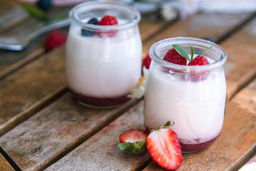 yoghurt with strawberries on wooden background