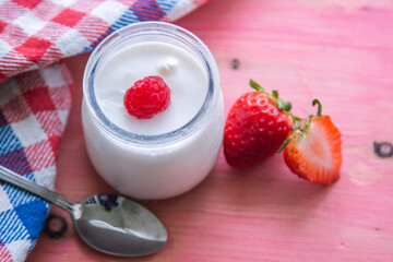 yogurt with strawberries on pink background