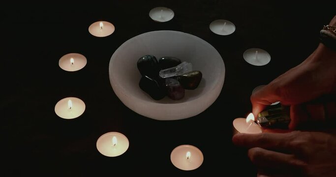 Lighting candles for a candle magick crystal cleansing ritual