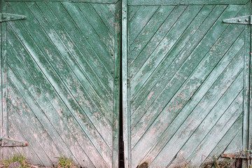old wooden green gate, close-up, boards at an angle