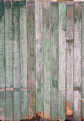 old fence with peeled green paint, uneven background, texture
