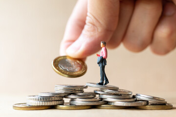 Miniature people businessman with coins. Business Growth concept