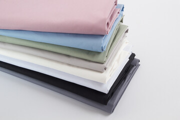 Rolls of bright colored fabric on a white background.